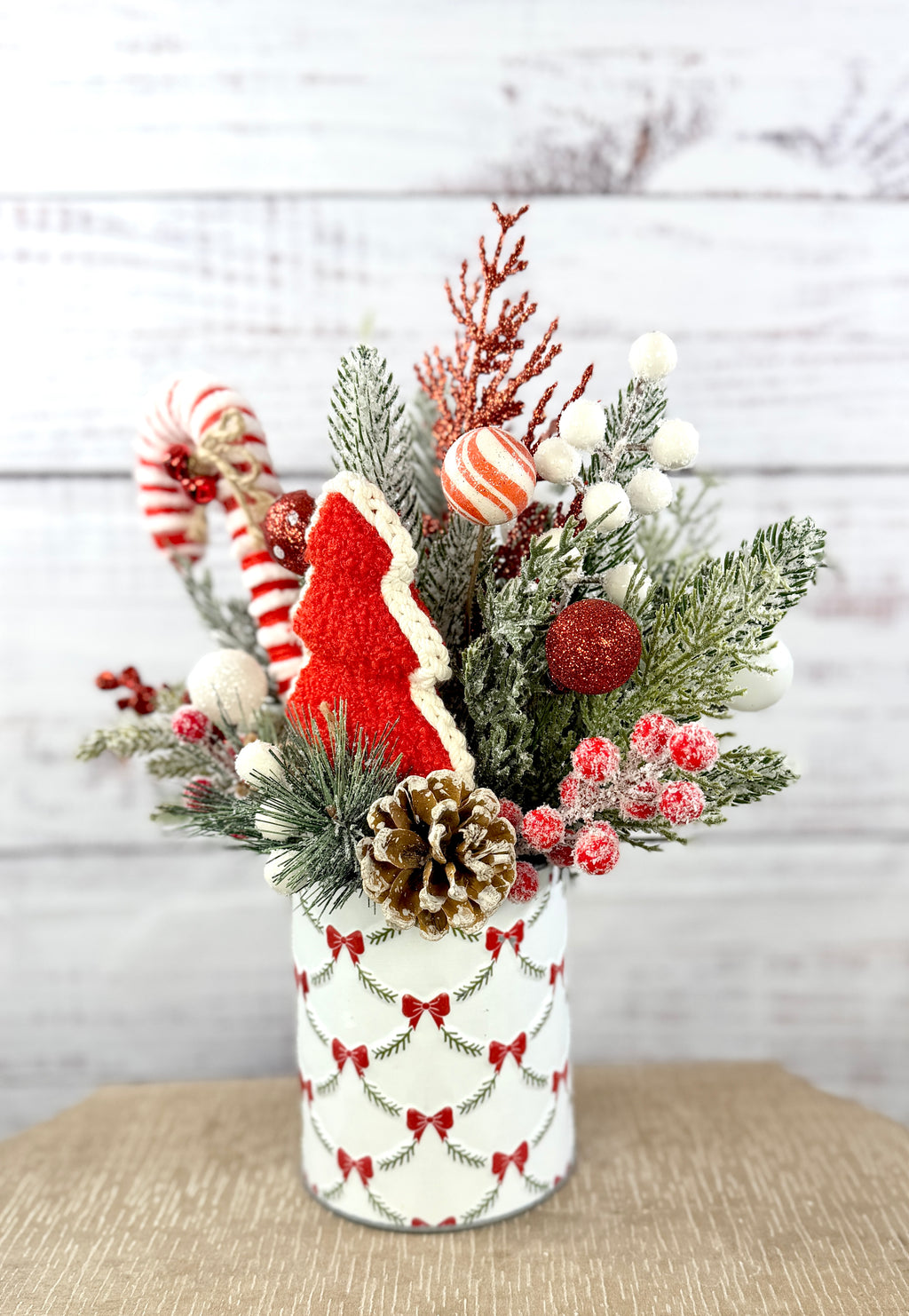 Side view with snow-tipped pinecone and frosted berries