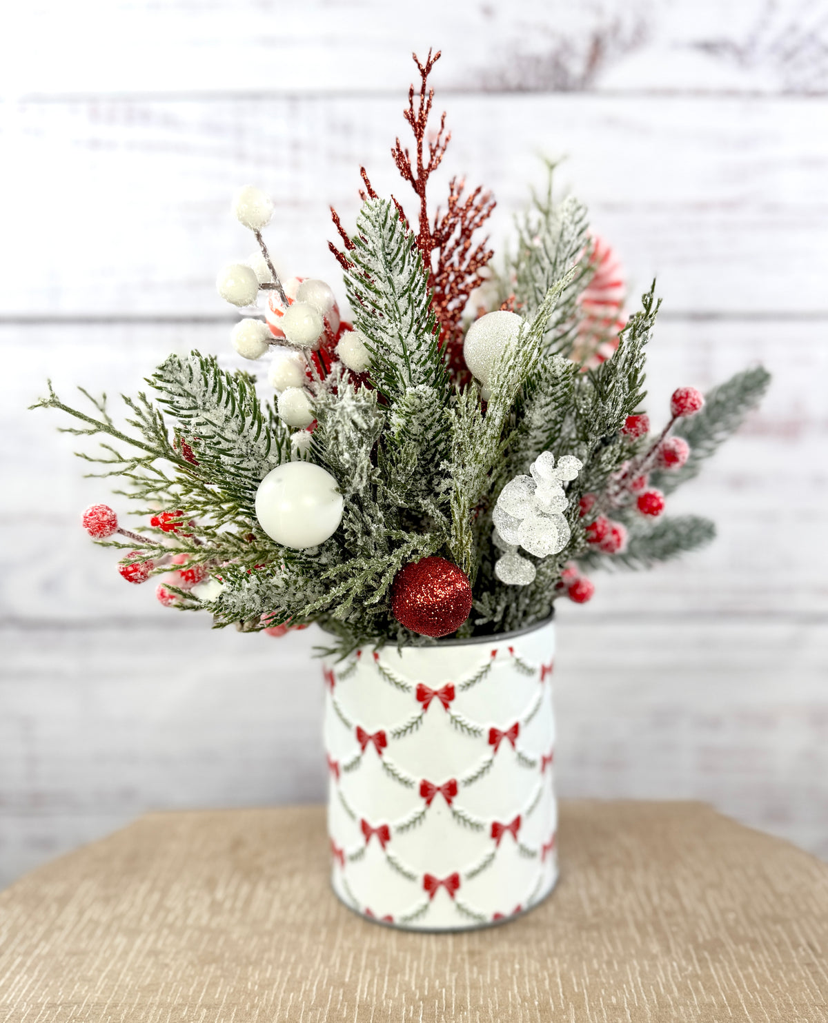 Snowy greenery with red and white ornaments