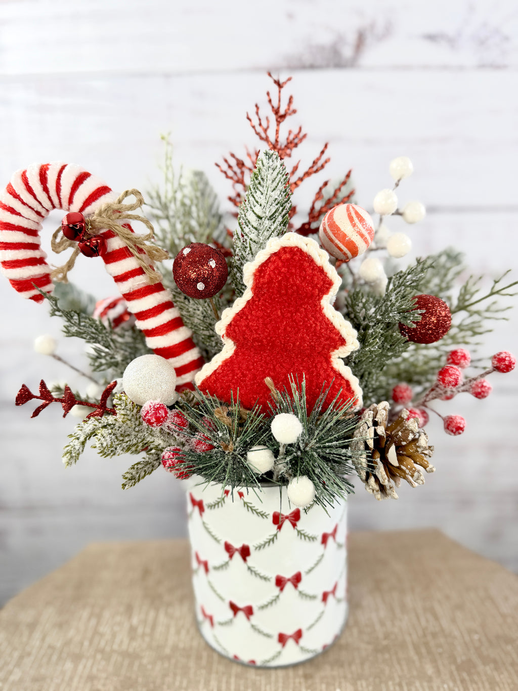 Close-up of textured red Christmas tree and candy cane