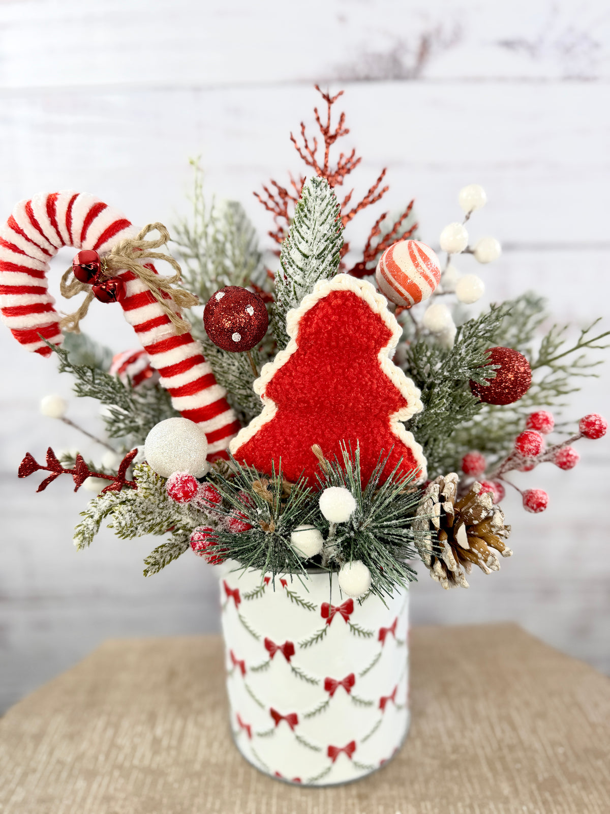 Close-up of textured red Christmas tree and candy cane