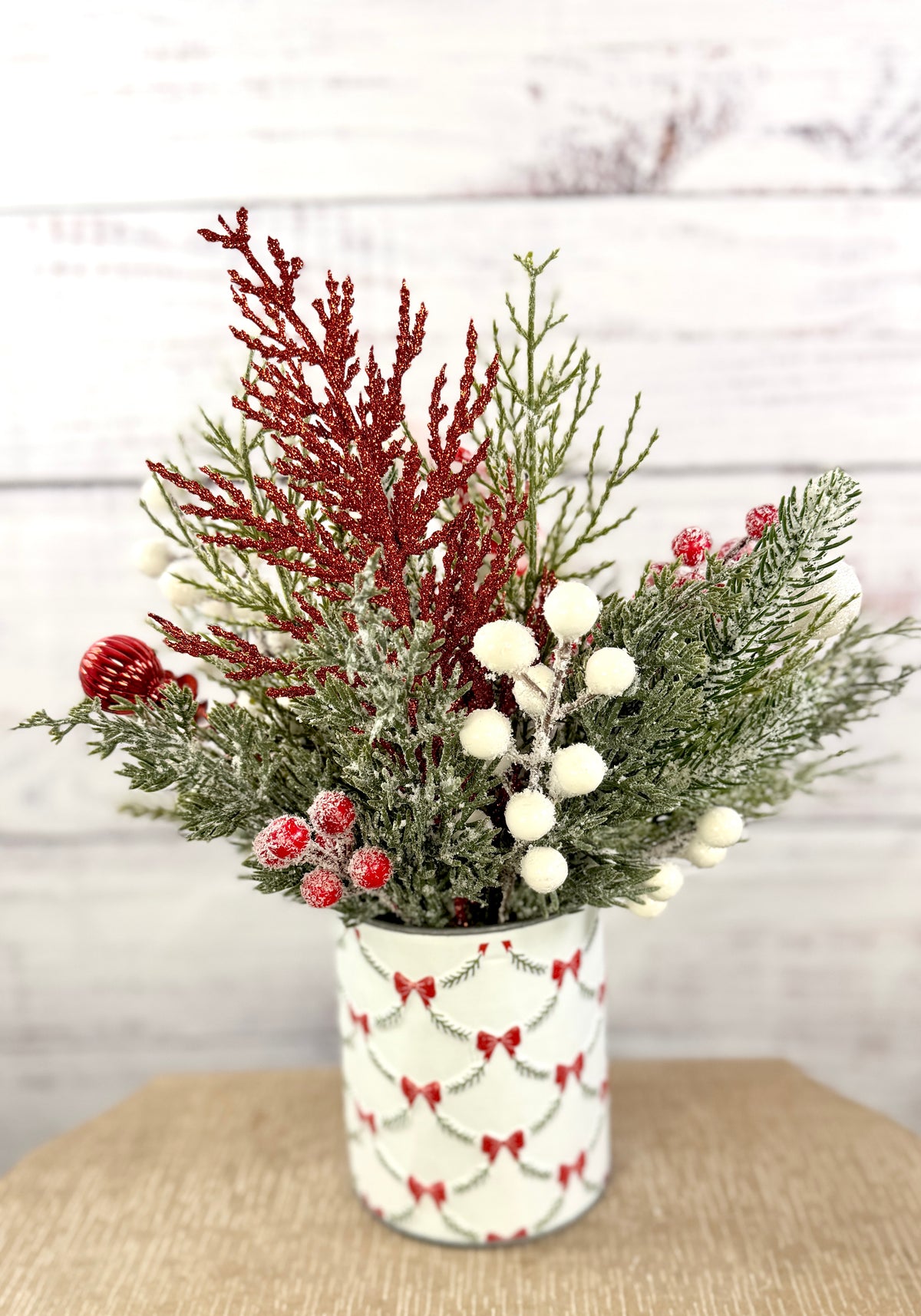 Rear view of frosted greenery and red glitter accents