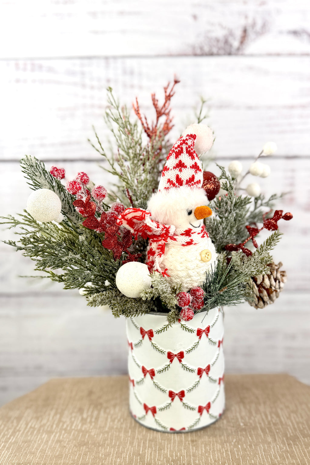 Side view of snowman and snowy greenery