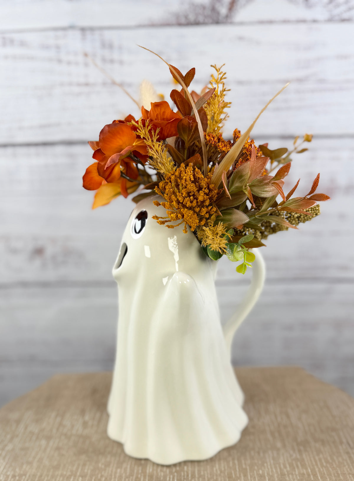 Autumn floral arrangement in a ceramic ghost pitcher, alternate view