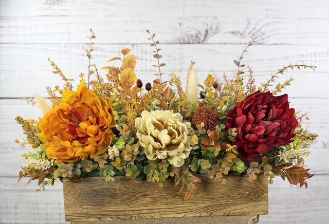 Autumn Harvest long fall floral arrangement with gold, cream and burgundy blooms in a rustic wood planter