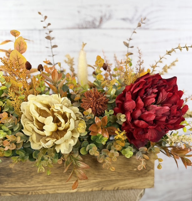 Autumn Harvest long fall floral arrangement with gold, cream and burgundy blooms in a rustic wood planter