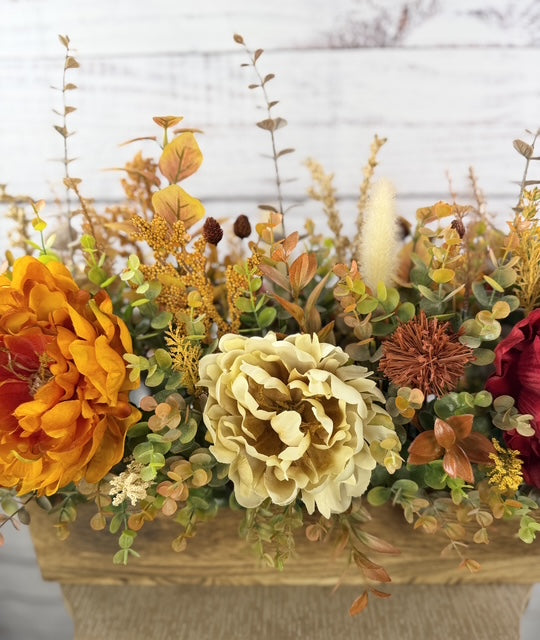 Autumn Harvest long fall floral arrangement with gold, cream and burgundy blooms in a rustic wood planter