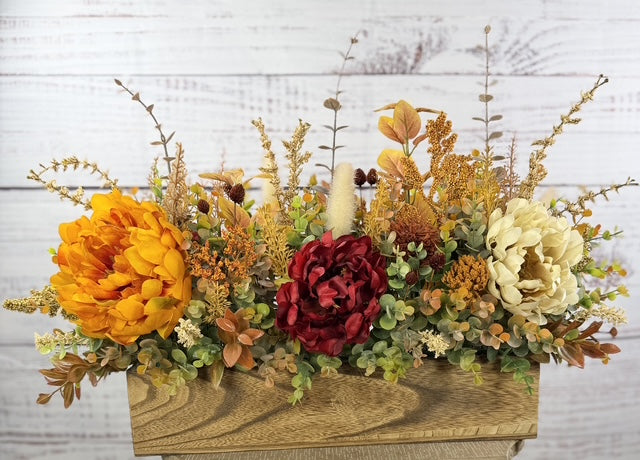Autumn Harvest long fall floral arrangement with gold, cream and burgundy blooms in a rustic wood planter