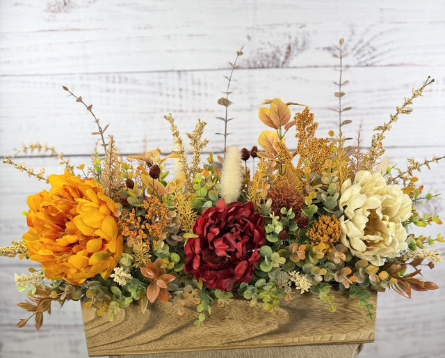 Autumn Harvest long fall floral arrangement with gold, cream and burgundy blooms in a rustic wood planter