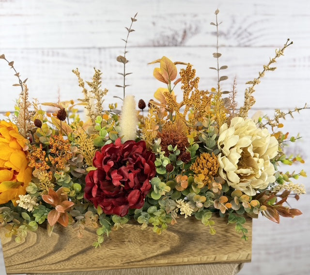 Autumn Harvest long fall floral arrangement with gold, cream and burgundy blooms in a rustic wood planter