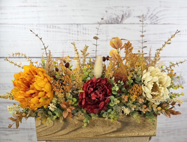 Autumn Harvest long fall floral arrangement with gold, cream and burgundy blooms in a rustic wood planter
