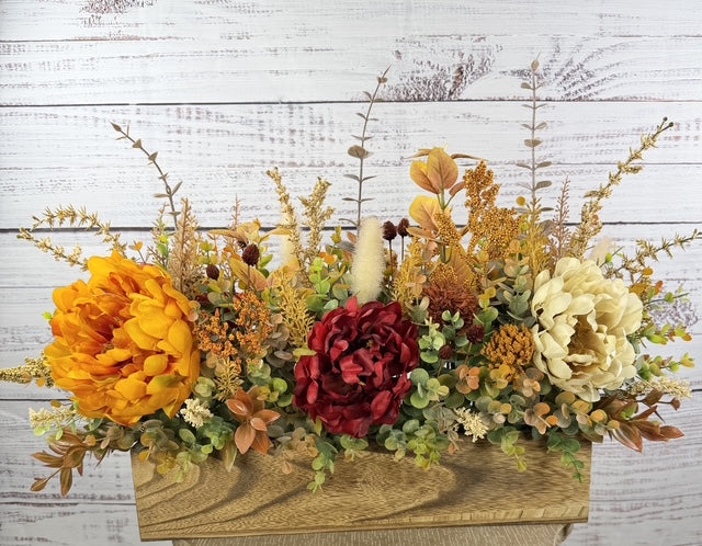 Autumn Harvest long fall floral arrangement with gold, cream and burgundy blooms in a rustic wood planter