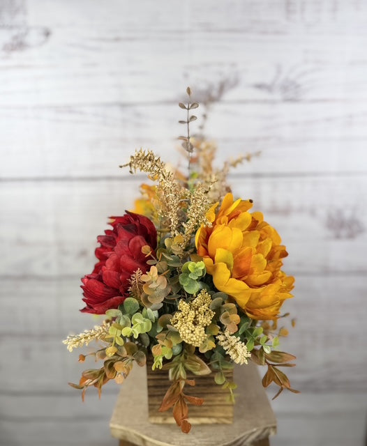 Autumn Harvest long fall floral arrangement with gold, cream and burgundy blooms in a rustic wood planter