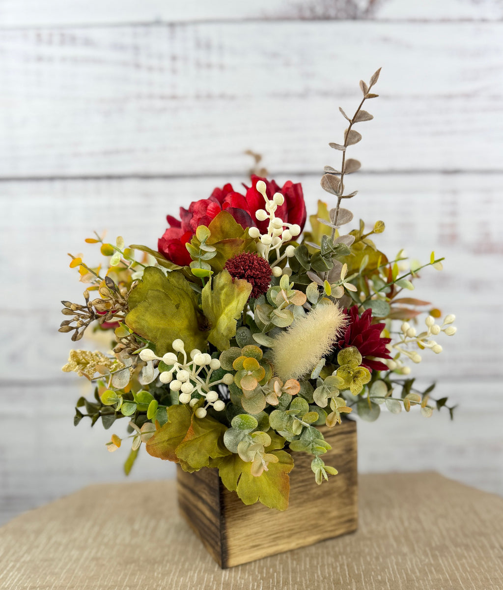 Garnet Grove burgundy and cream fall floral arrangement with green foliage in a rustic wooden cube