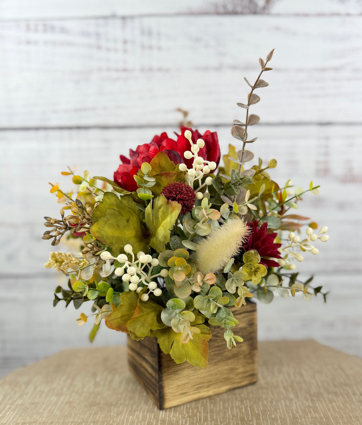 Garnet Grove burgundy and cream fall floral arrangement with green foliage in a rustic wooden cube