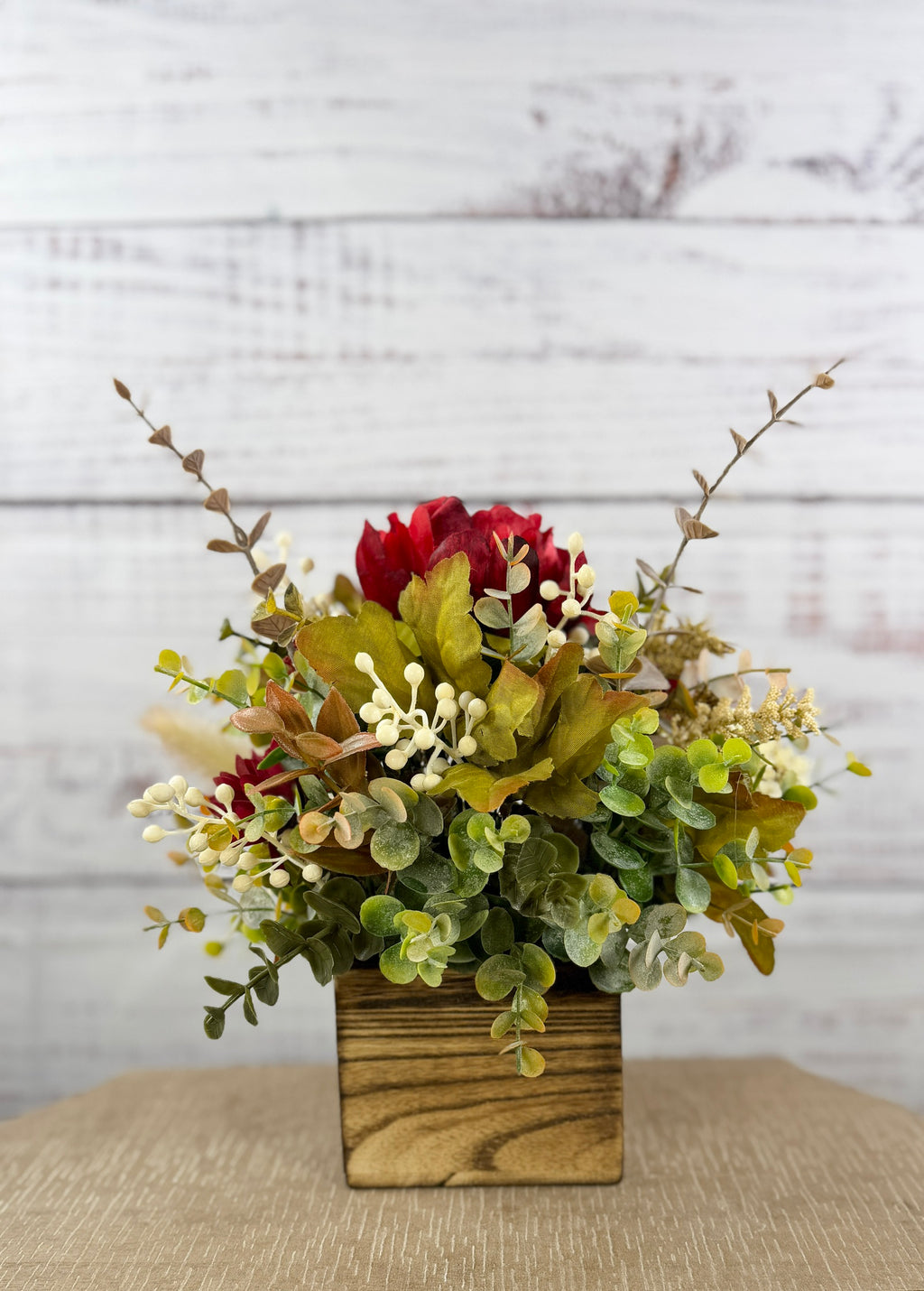 Garnet Grove burgundy and cream fall floral arrangement with green foliage in a rustic wooden cube