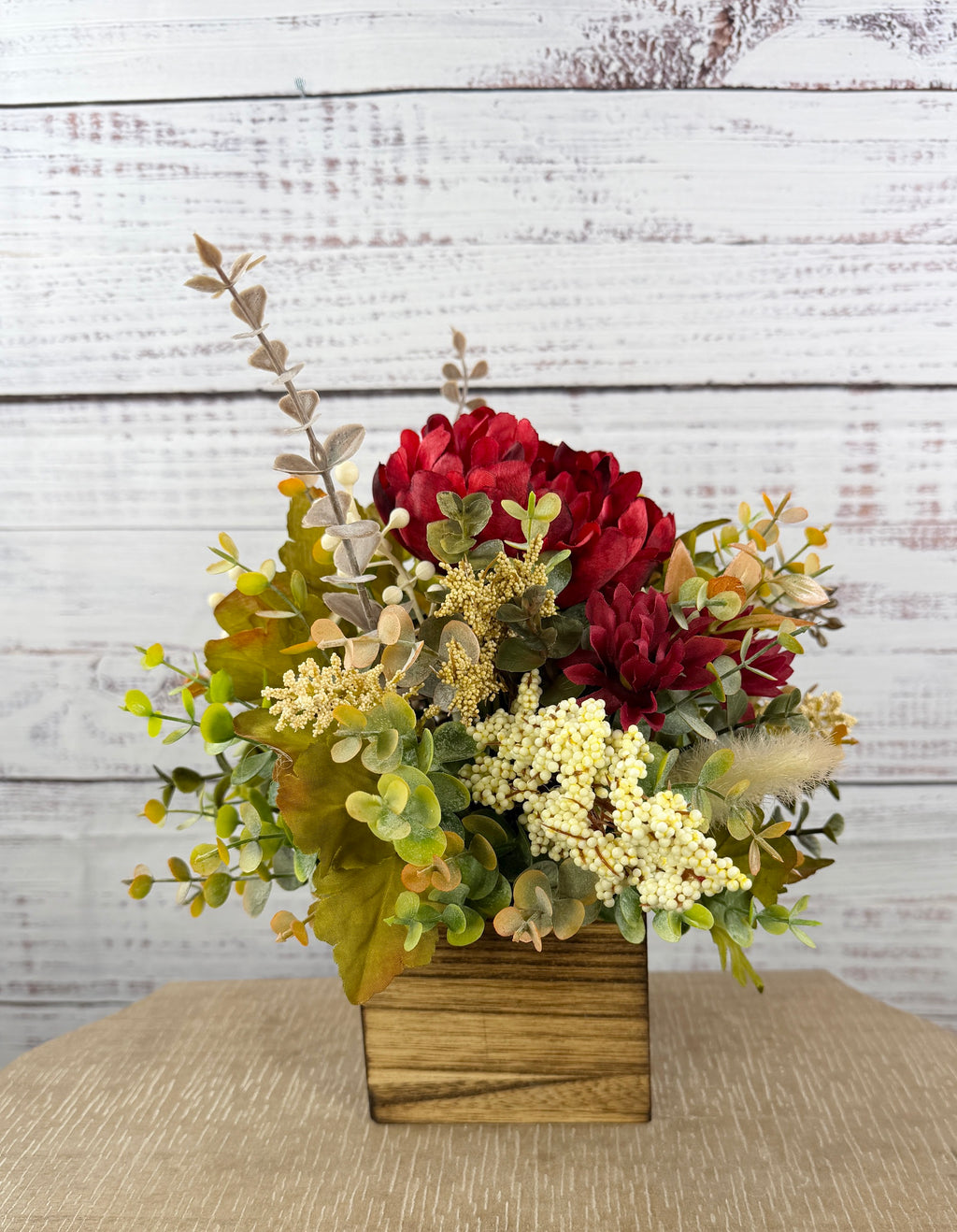Garnet Grove burgundy and cream fall floral arrangement with green foliage in a rustic wooden cube