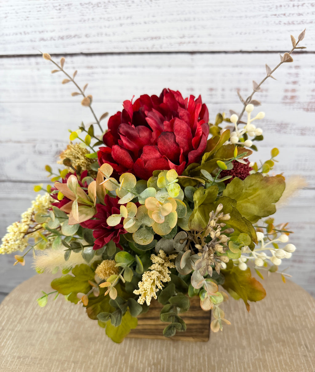 Garnet Grove burgundy and cream fall floral arrangement with green foliage in a rustic wooden cube