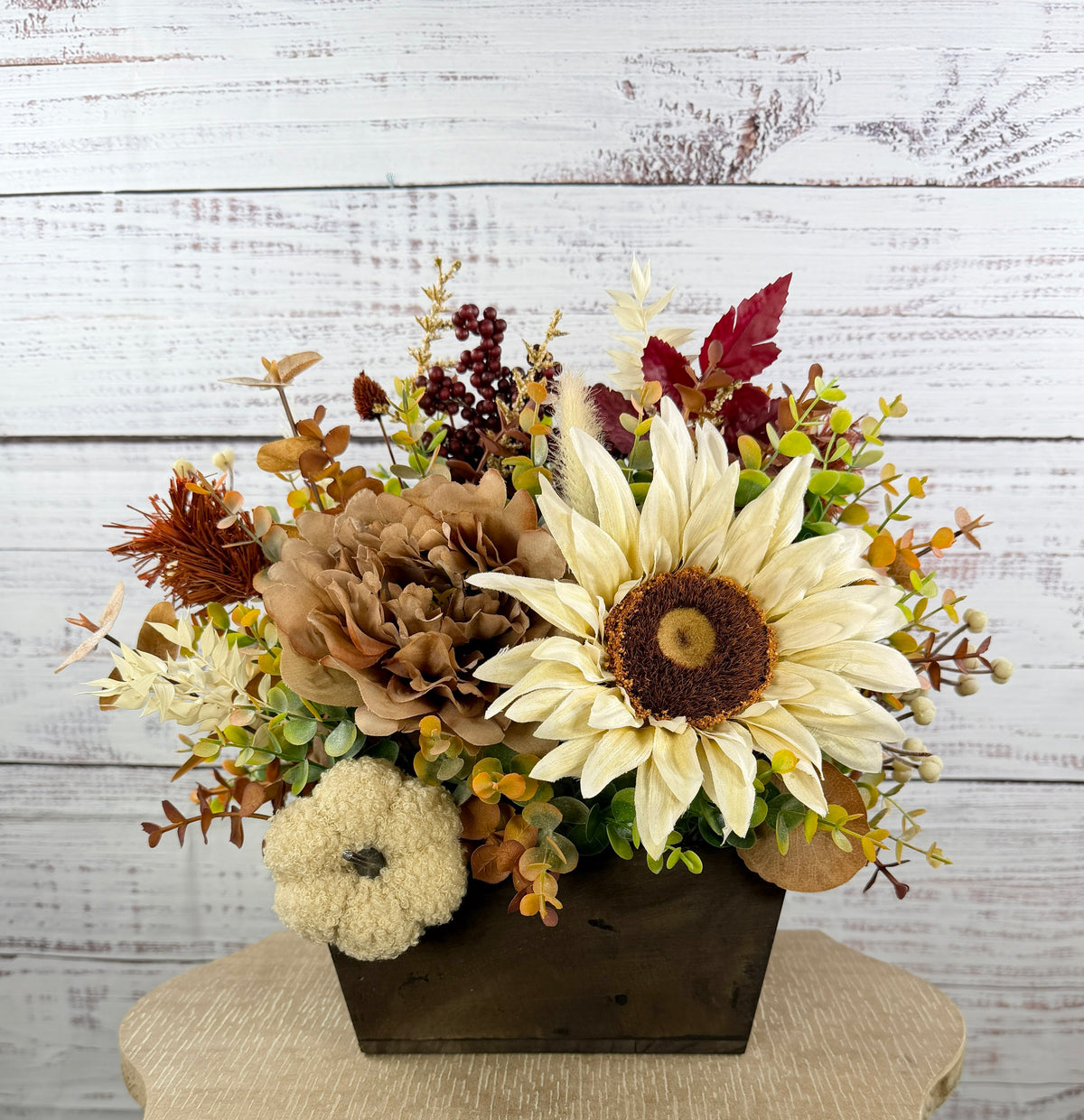 Ivory Harvest fall floral arrangement with cream and taupe flowers, autumn greenery and a decorative pumpkin in a dark wood box