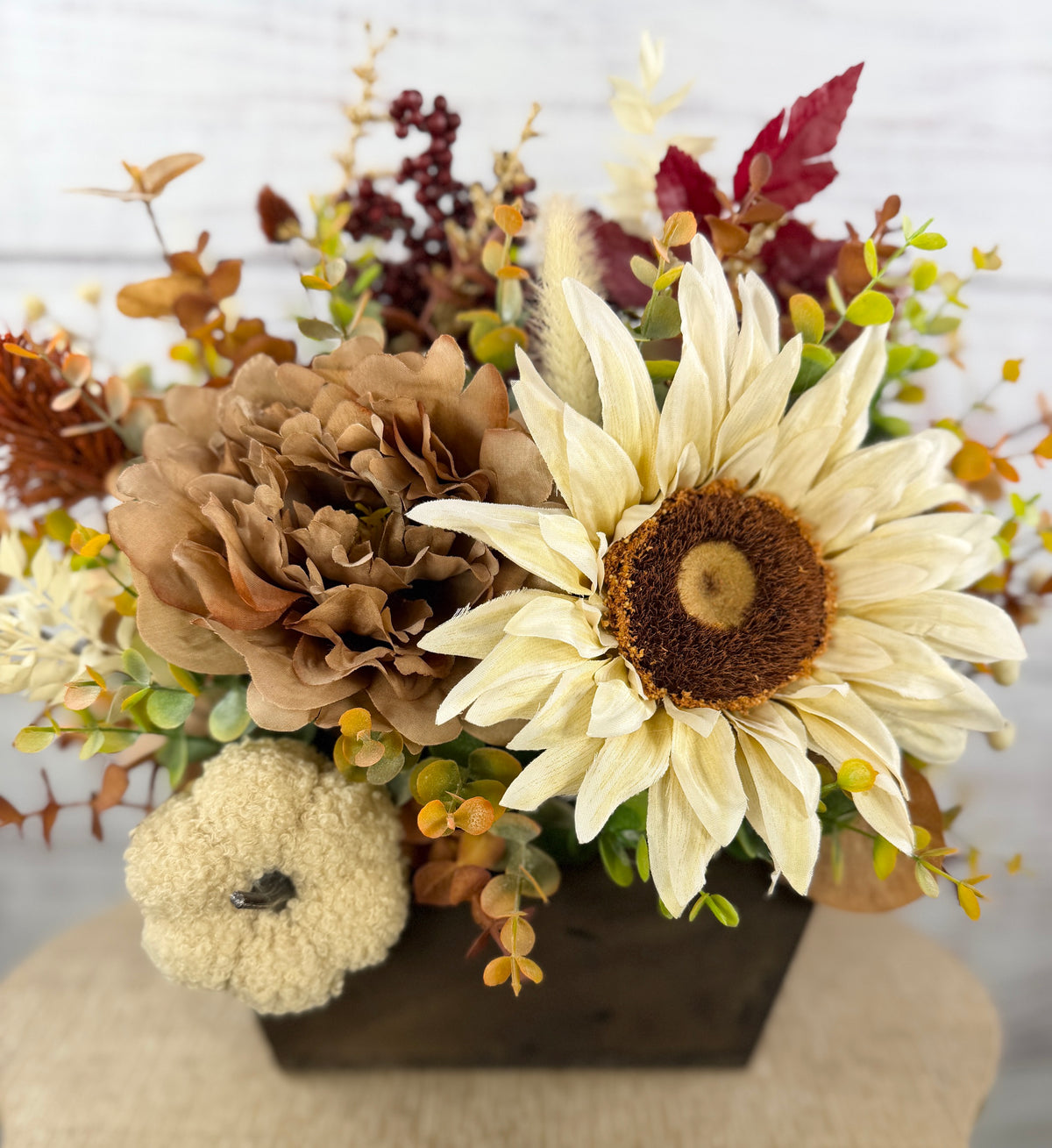 Ivory Harvest fall floral arrangement with cream and taupe flowers, autumn greenery and a decorative pumpkin in a dark wood box