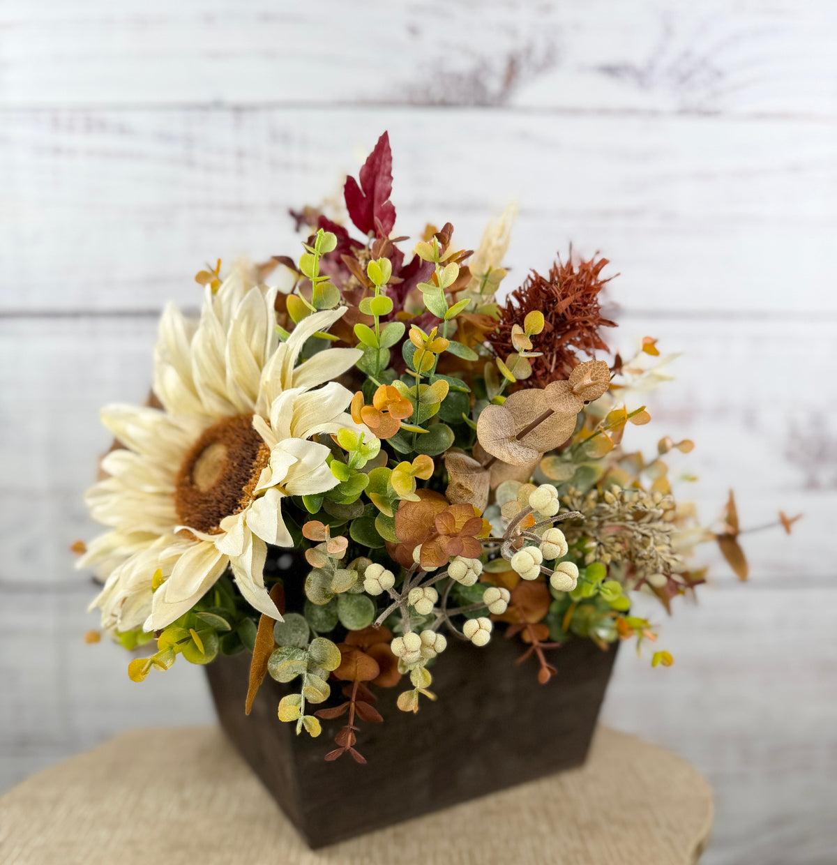 Ivory Harvest fall floral arrangement with cream and taupe flowers, autumn greenery and a decorative pumpkin in a dark wood box
