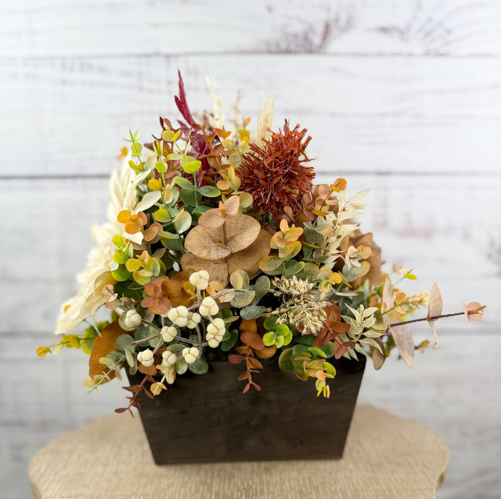 Ivory Harvest fall floral arrangement with cream and taupe flowers, autumn greenery and a decorative pumpkin in a dark wood box
