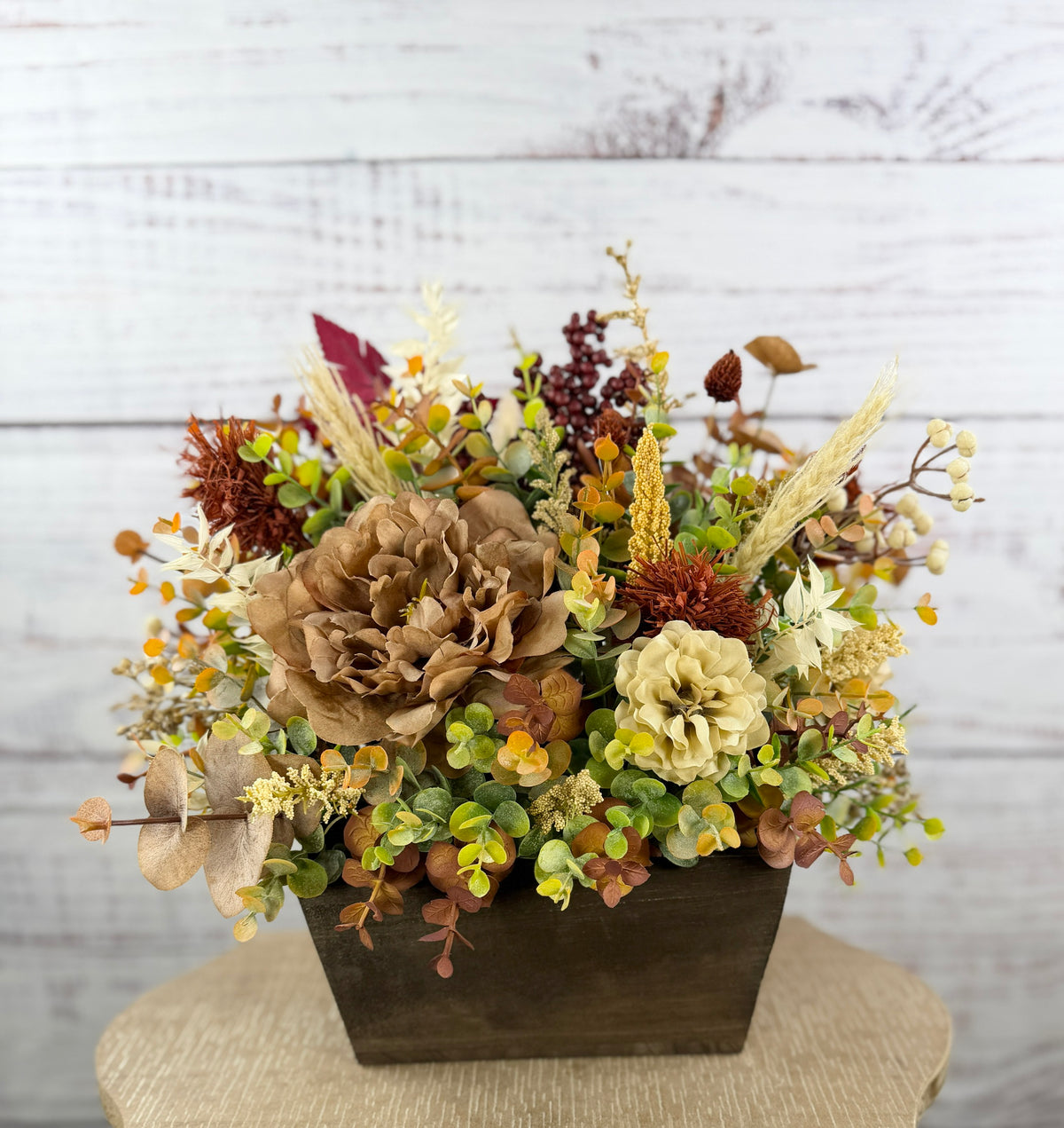 Ivory Harvest fall floral arrangement with cream and taupe flowers, autumn greenery and a decorative pumpkin in a dark wood box