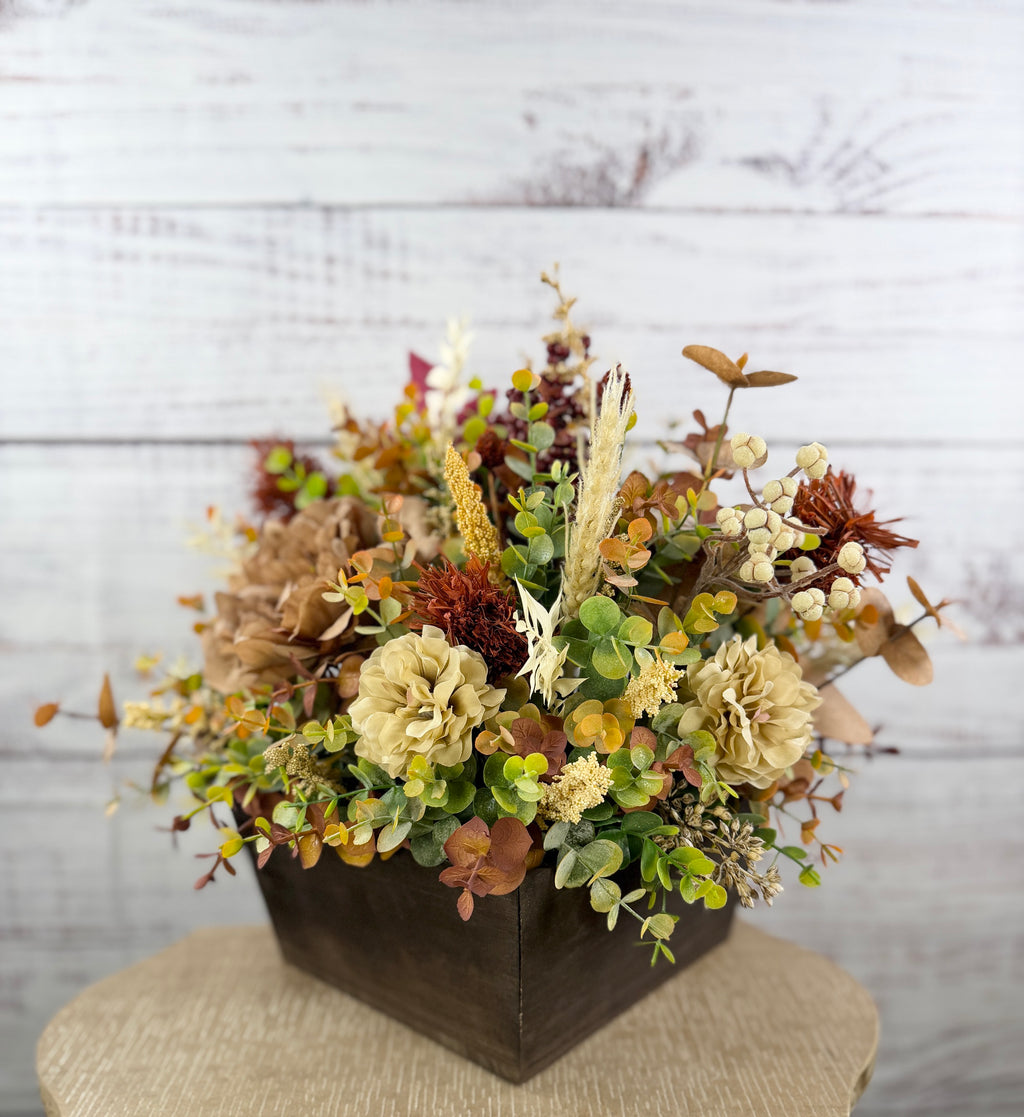 Ivory Harvest fall floral arrangement with cream and taupe flowers, autumn greenery and a decorative pumpkin in a dark wood box