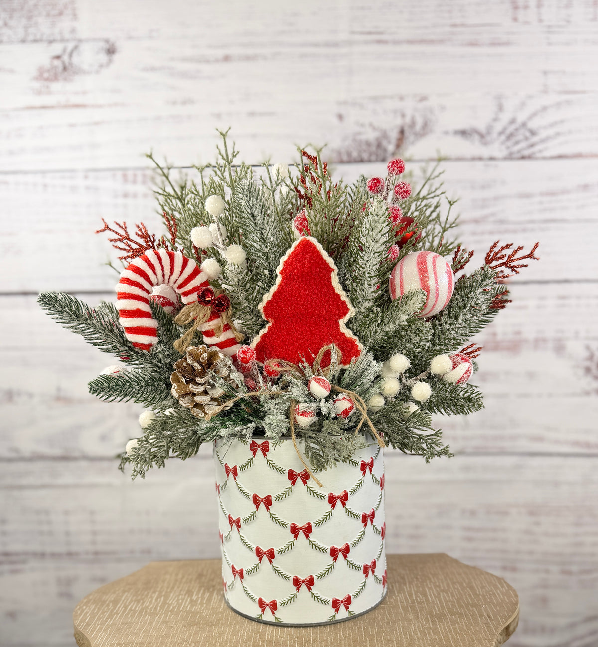 Front view of large Christmas arrangement in bow-patterned tin