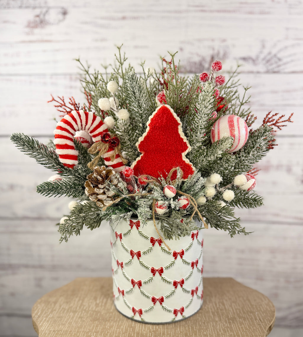 Large candy cane Christmas arrangement in white bow-patterned holiday tin