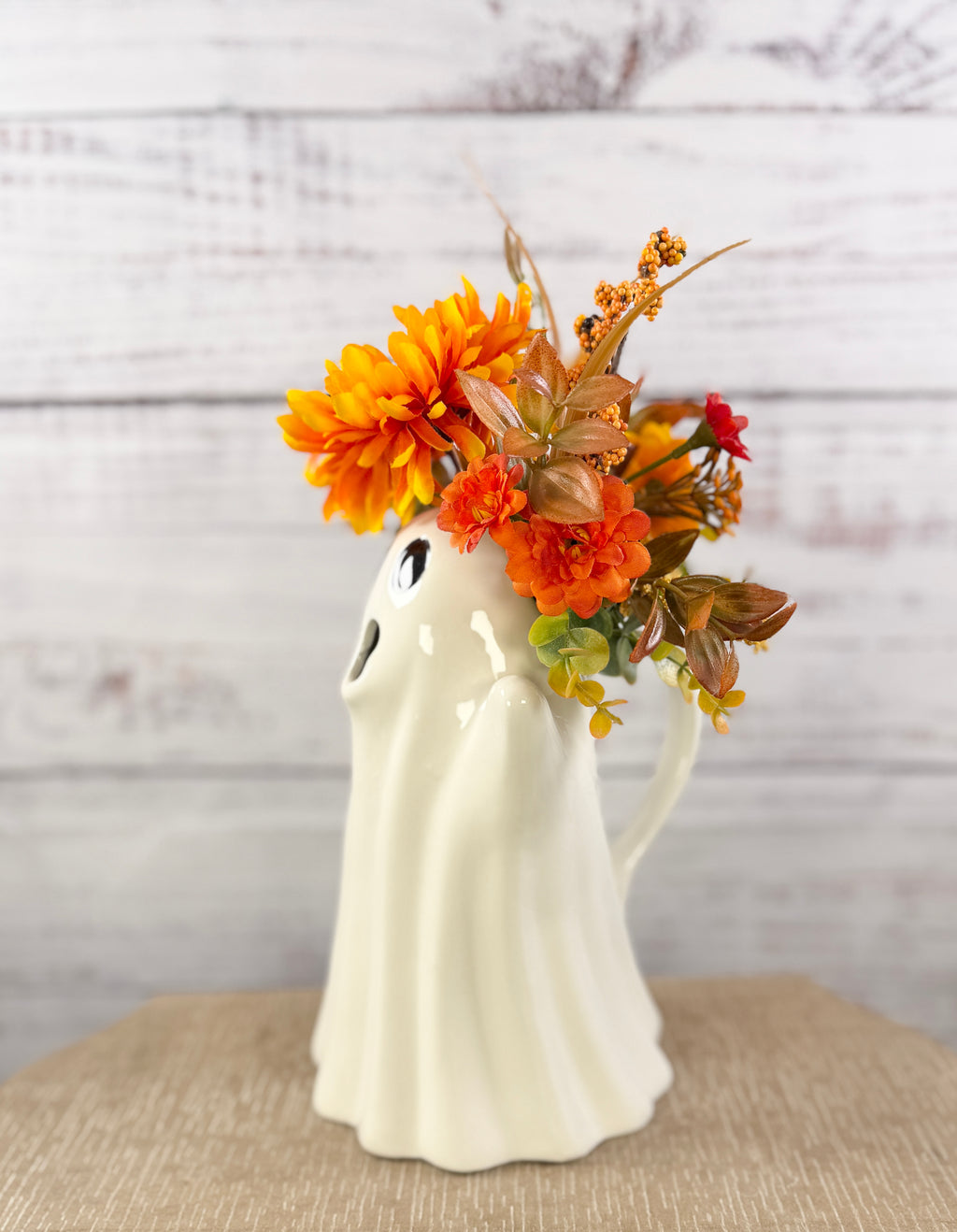 Marigold Boo ceramic ghost pitcher with orange and golden faux flowers