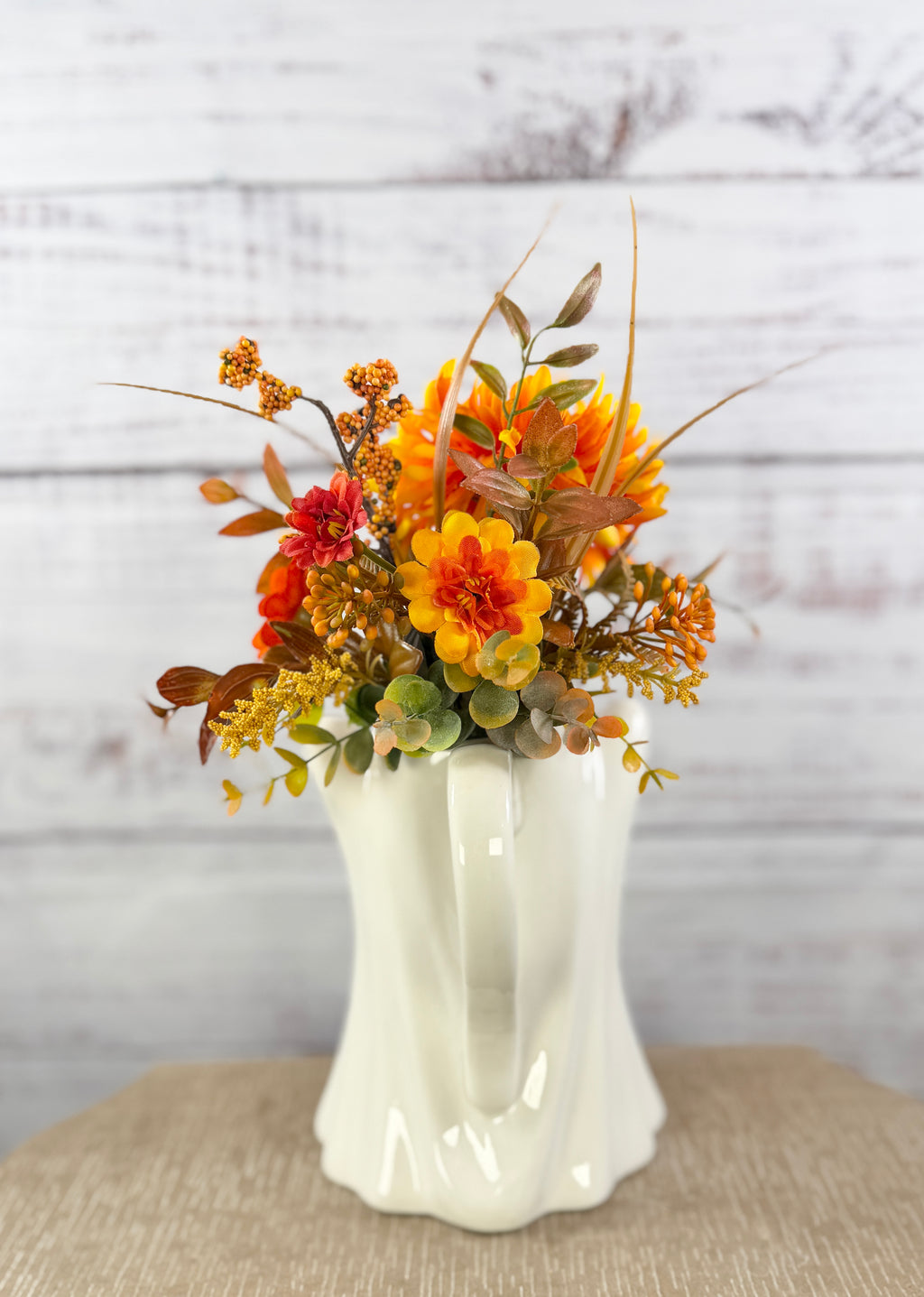 Marigold Boo ceramic ghost pitcher with orange and golden faux flowers