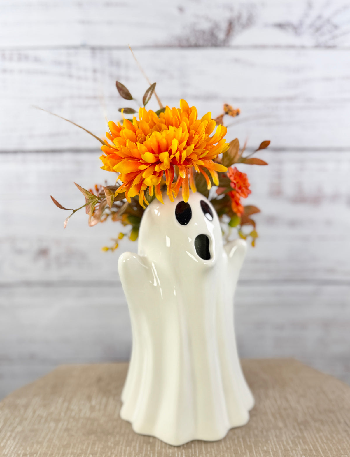 Marigold Boo ceramic ghost pitcher with orange and golden faux flowers