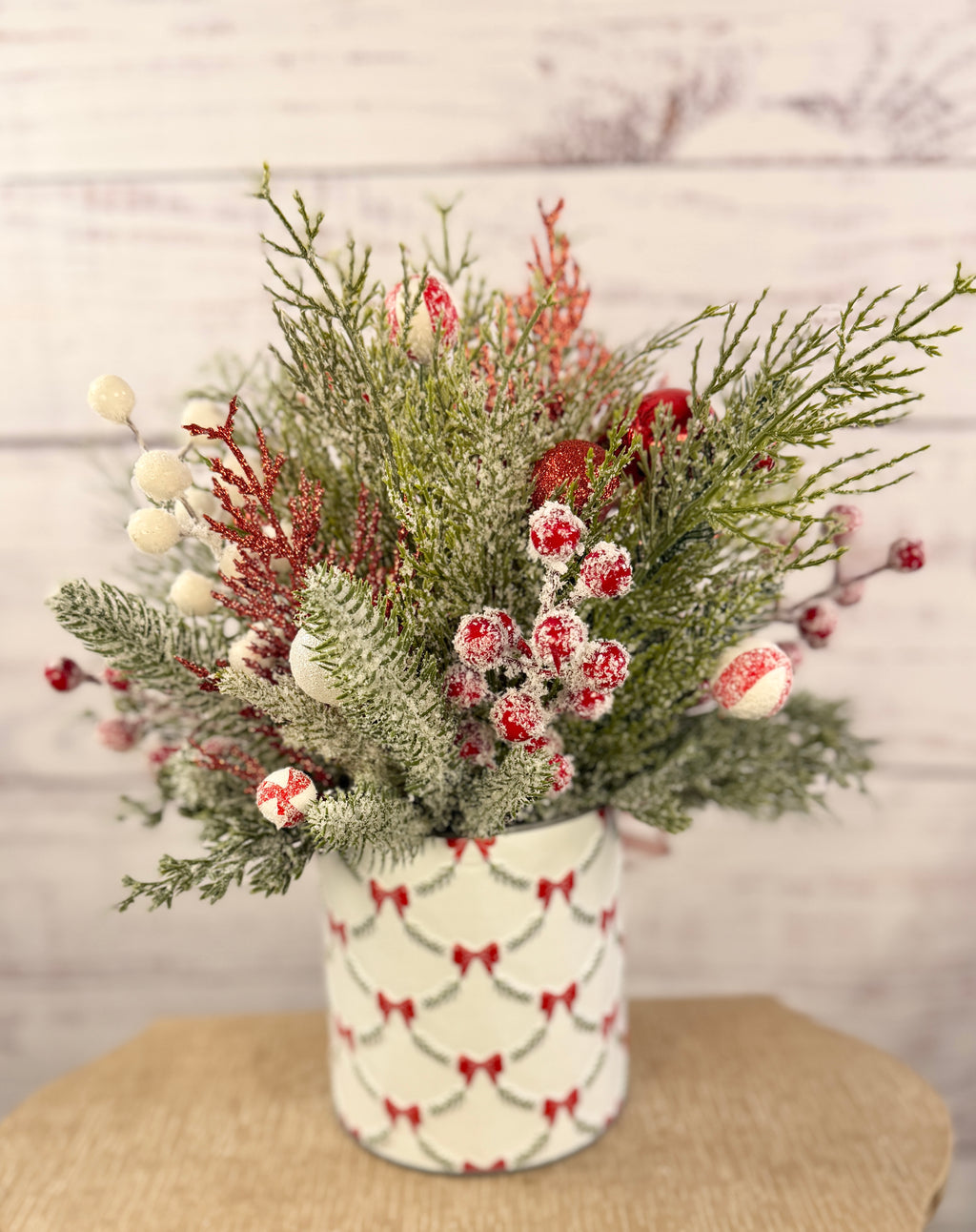 Handmade peppermint Christmas arrangement, back view of snowy greenery and bow patterned tin