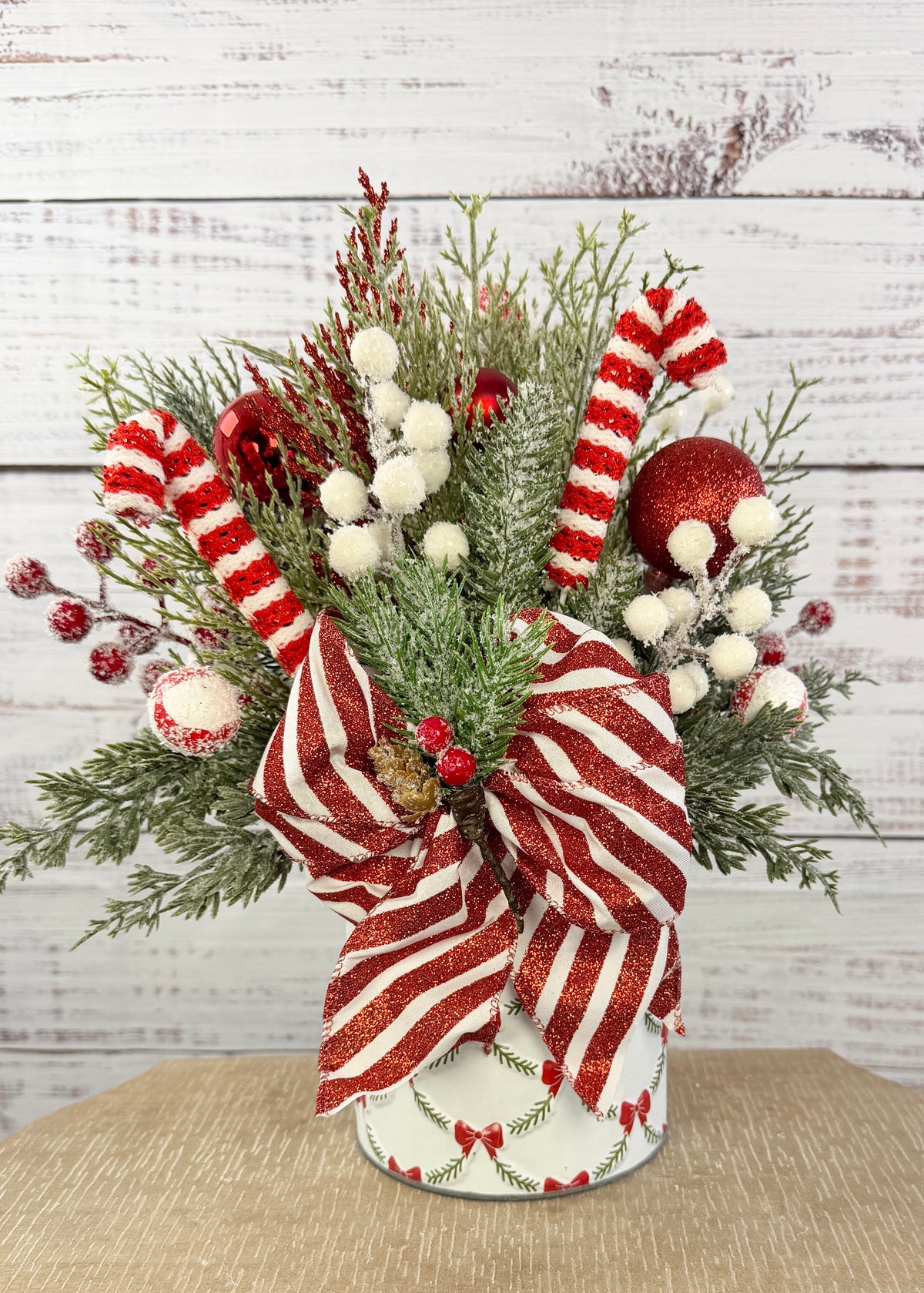 Candy cane Christmas arrangement in bow and garland tin, full front view