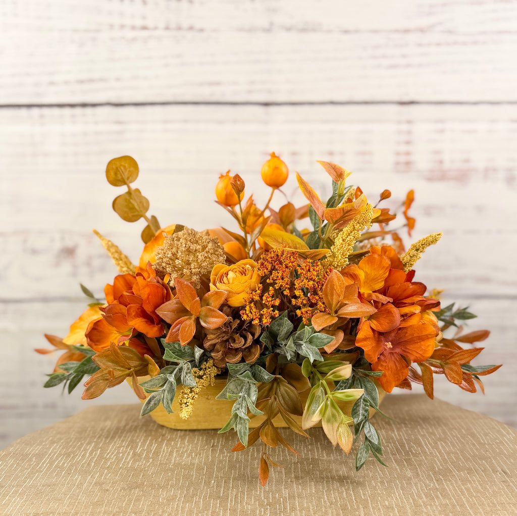 Back view with autumn flowers and pinecone