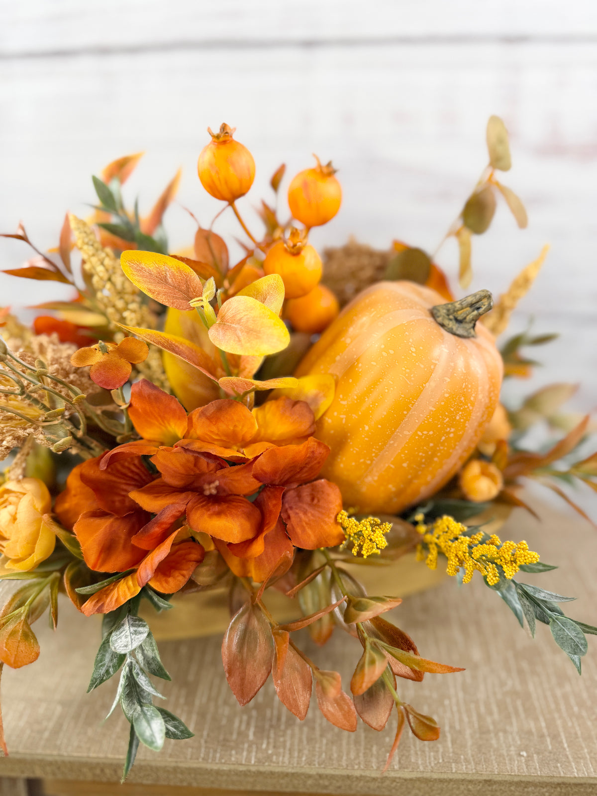 Close-up of pumpkin and orange flowers