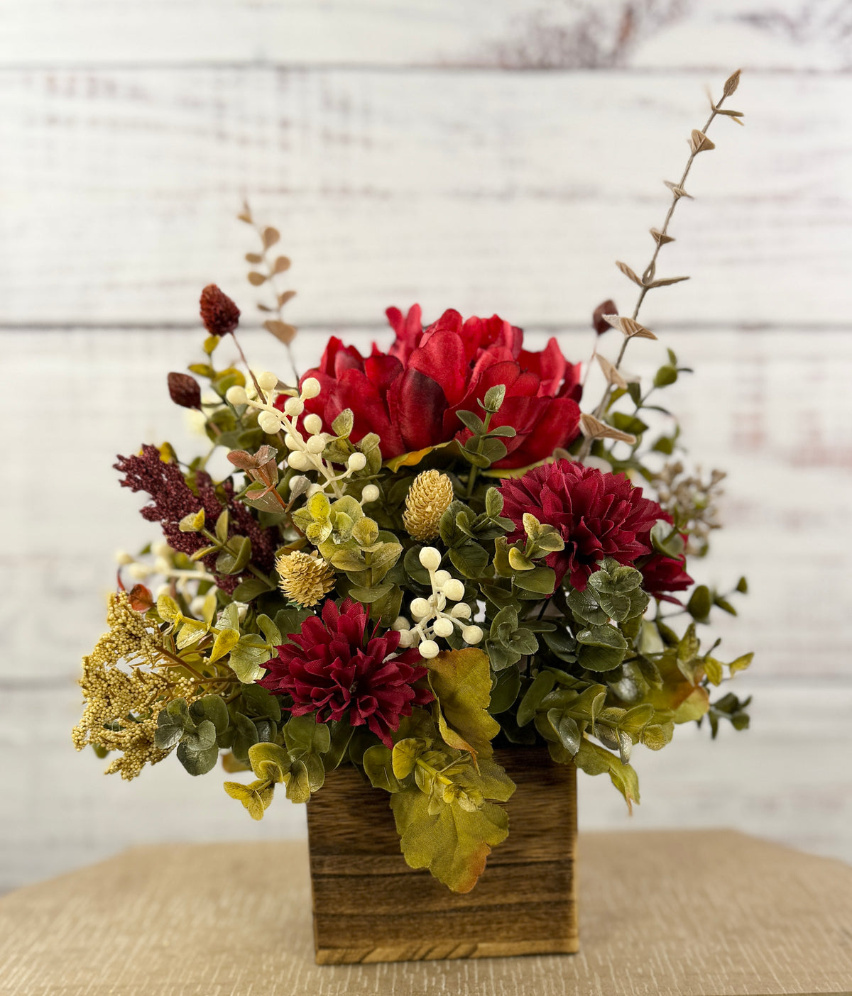 Ruby Harvest red and burgundy floral arrangement in a rustic wood cube