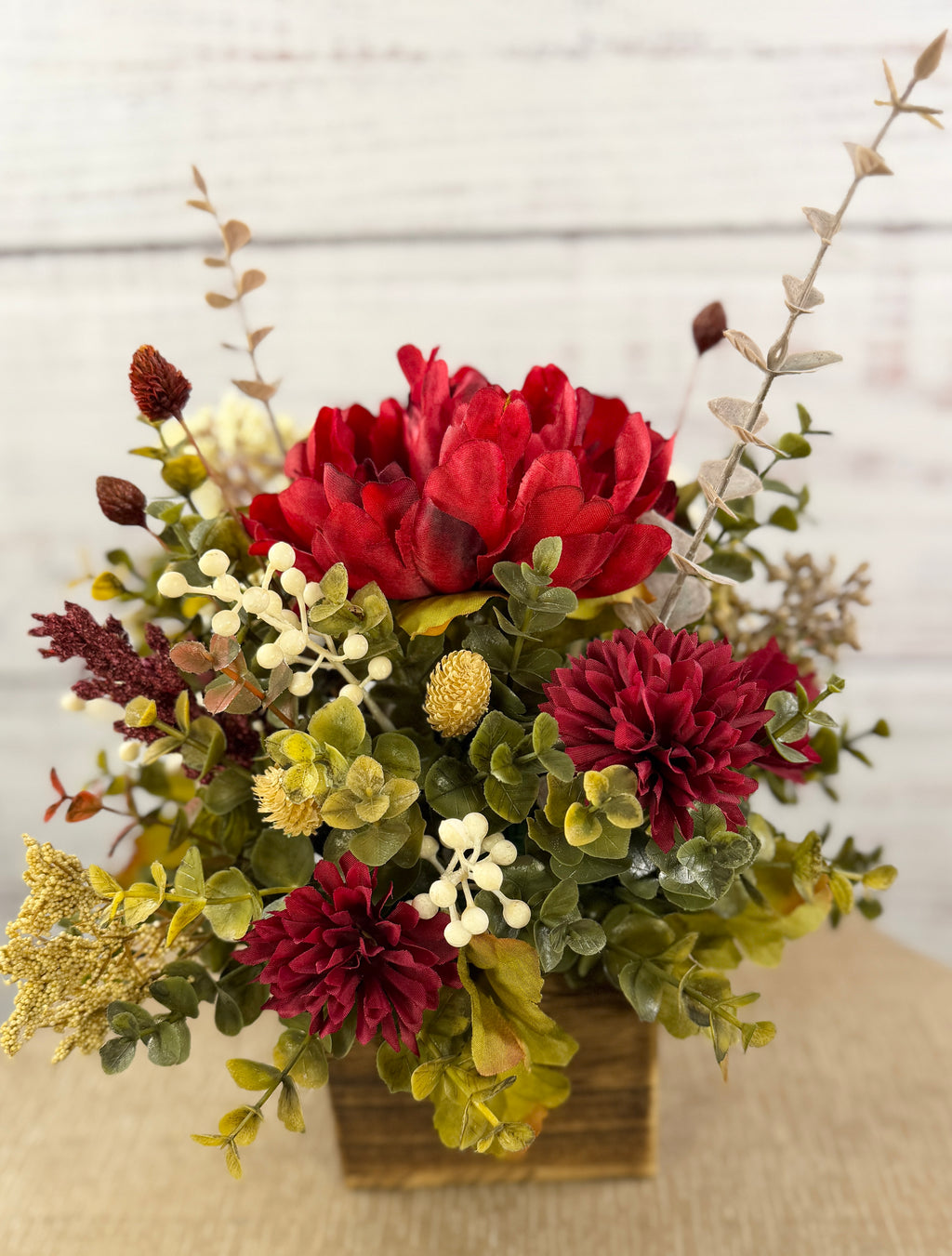 Ruby Harvest red and burgundy floral arrangement in a rustic wood cube