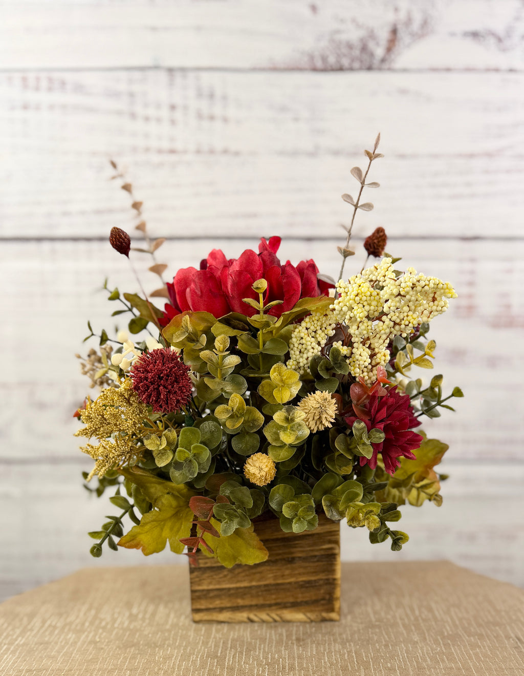 Ruby Harvest red and burgundy floral arrangement in a rustic wood cube
