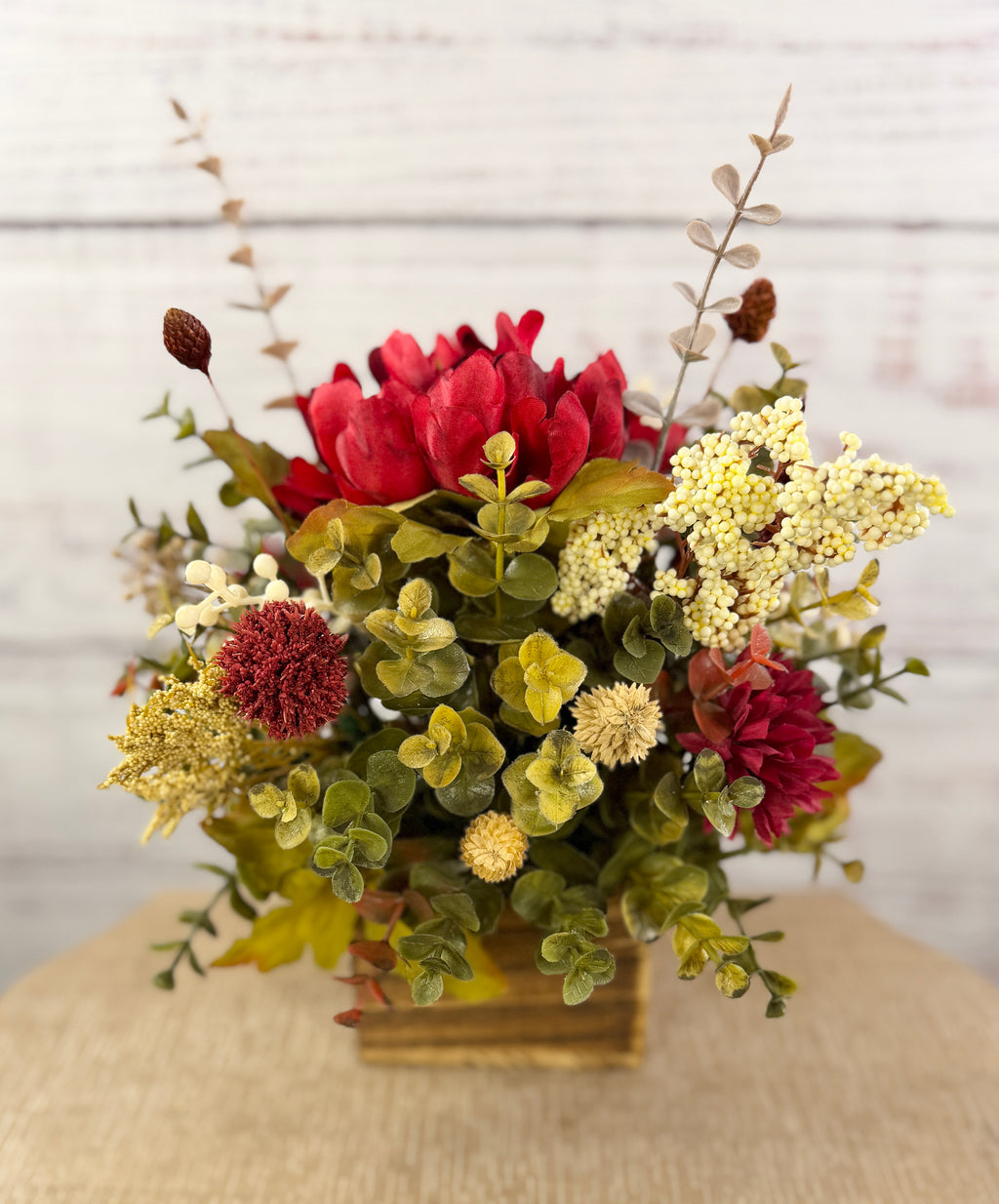 Ruby Harvest red and burgundy floral arrangement in a rustic wood cube