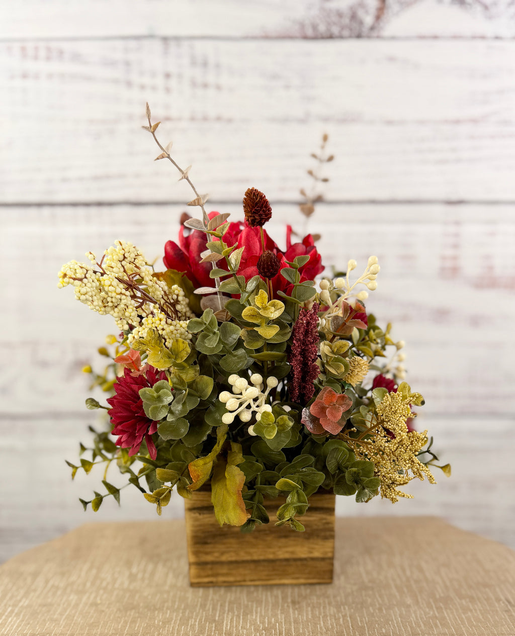 Ruby Harvest red and burgundy floral arrangement in a rustic wood cube