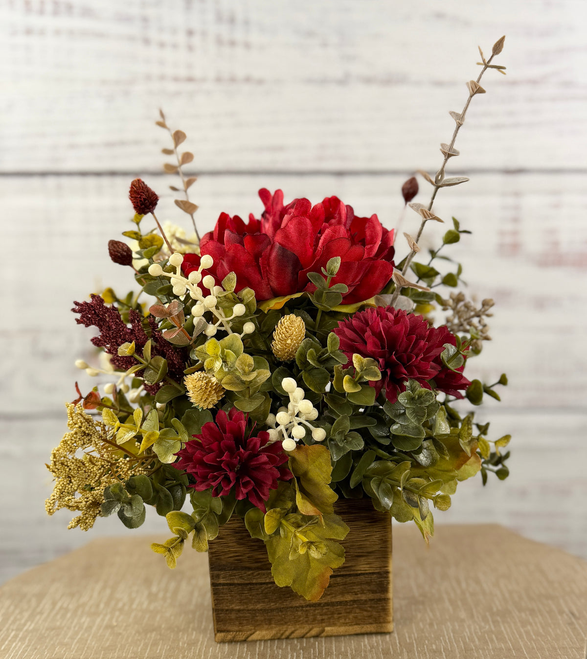 Ruby Harvest red and burgundy floral arrangement in a rustic wood cube