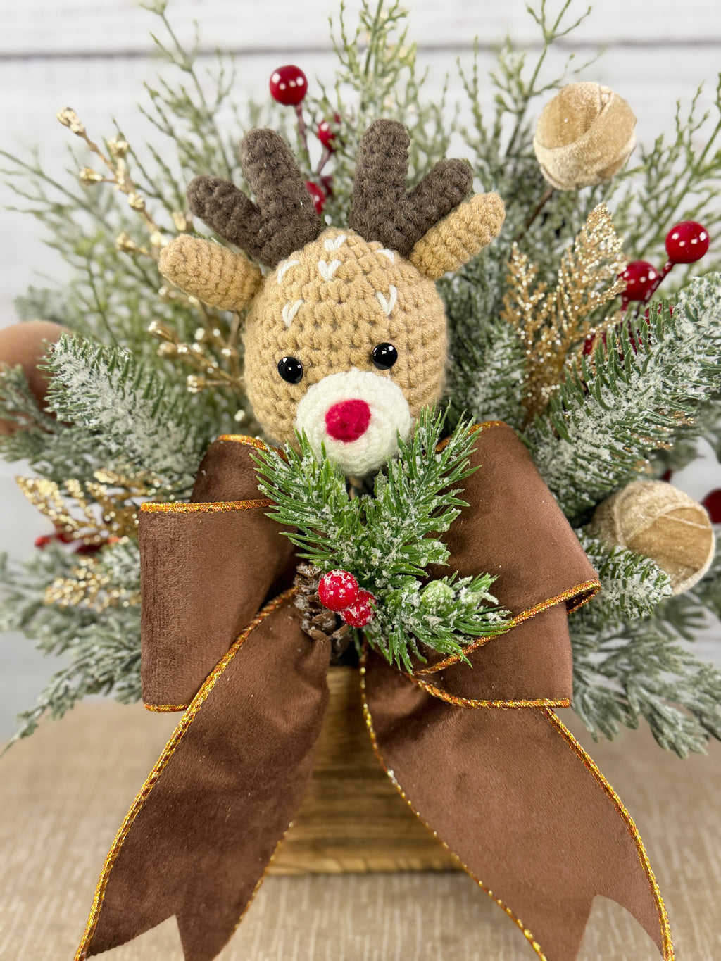Close-up of reindeer and gold-edged brown bow