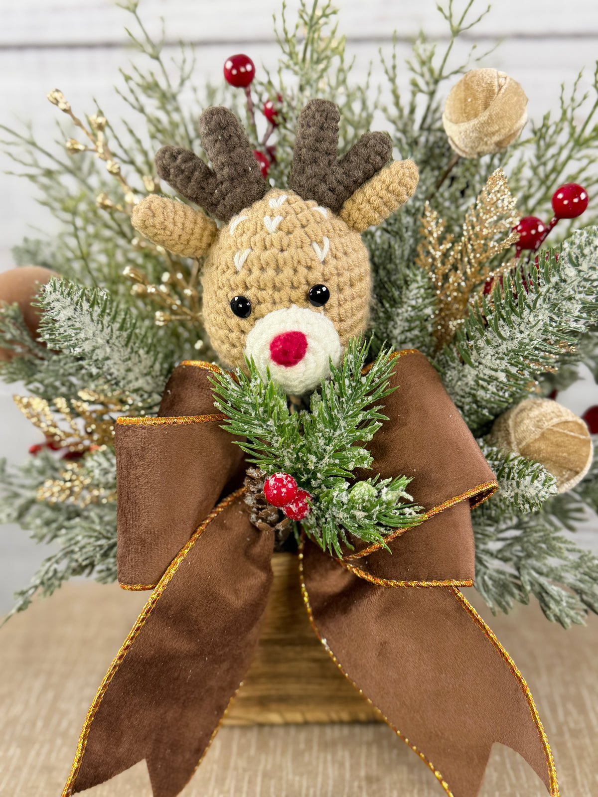 Close-up of reindeer and gold-edged brown bow