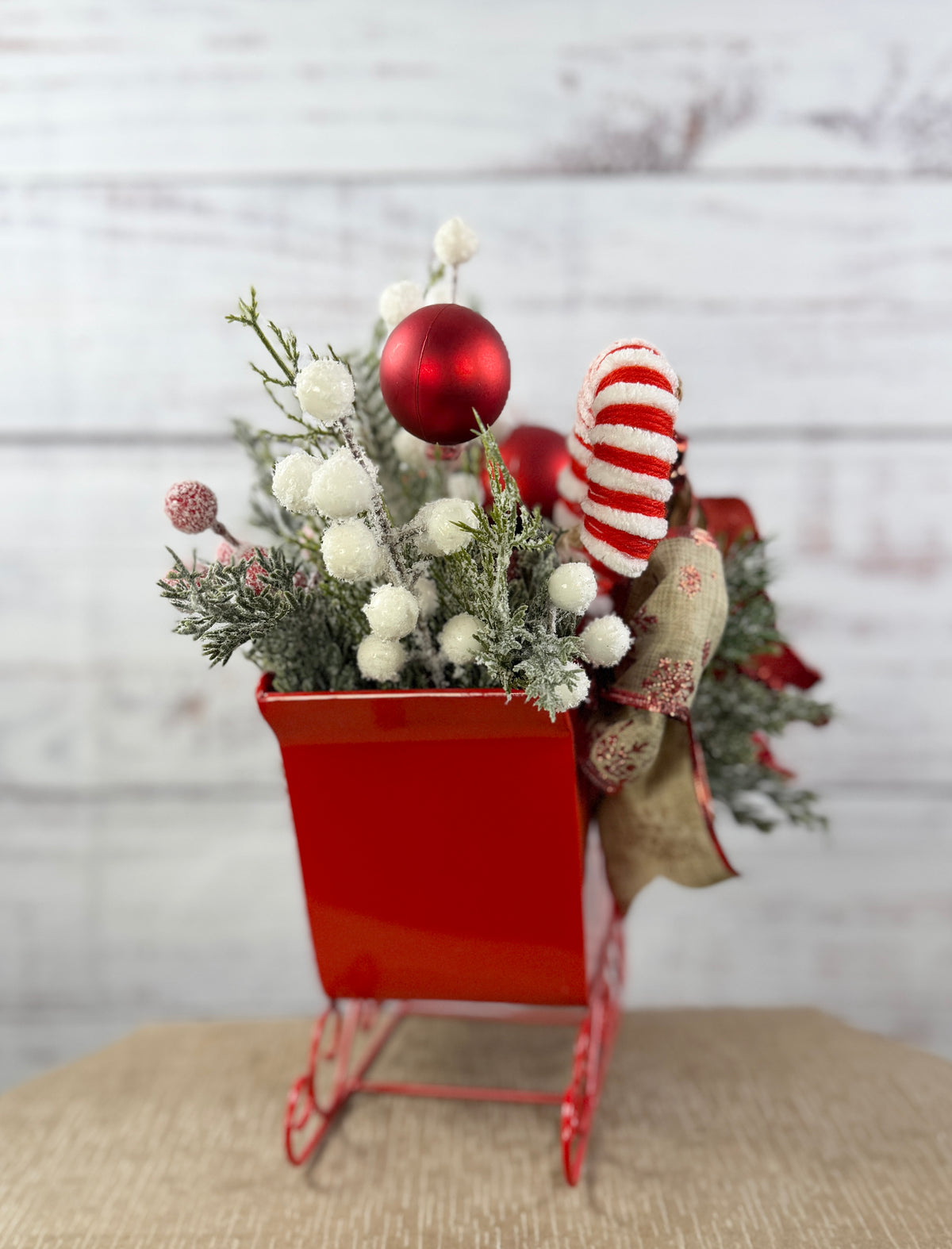End view of red metal sleigh arrangement
